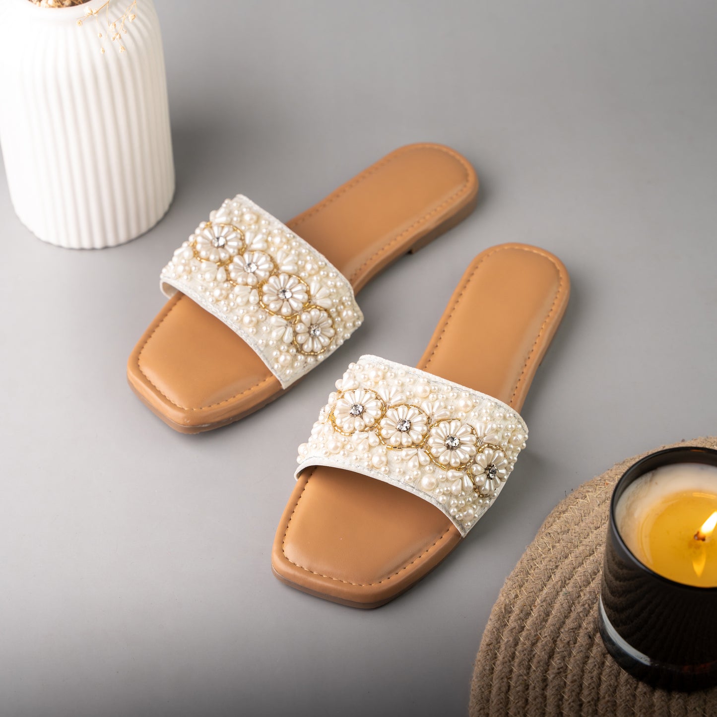 Stylish flat sliders with intricate flower and pearl detailing on strap
