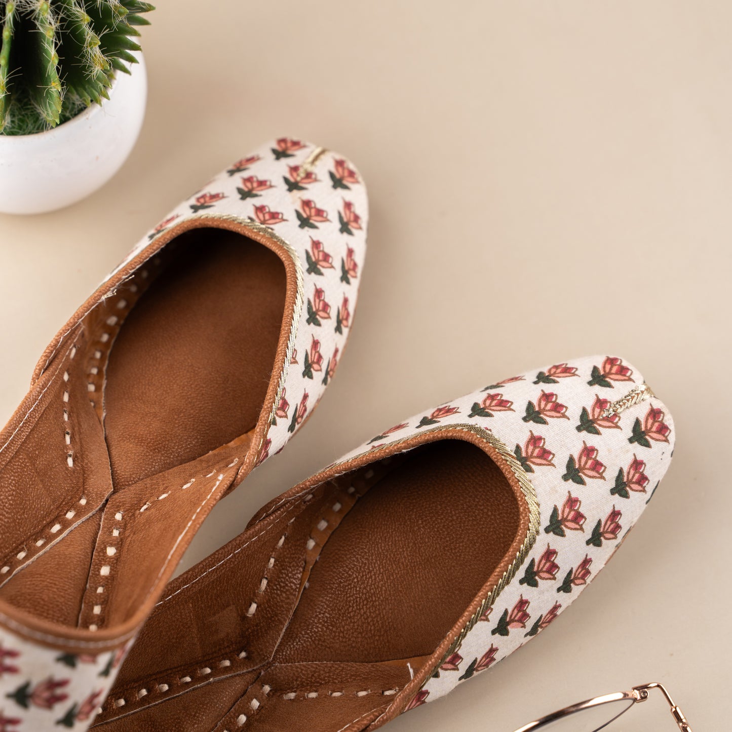 White Lucknowi juttis for women, handcrafted with intricate chikankari embroidery and soft soles, perfect for weddings, festivals, and everyday elegance.