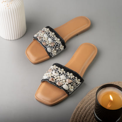 Sleek black sliders designed with a natural sea shell motif for a coastal-chic look